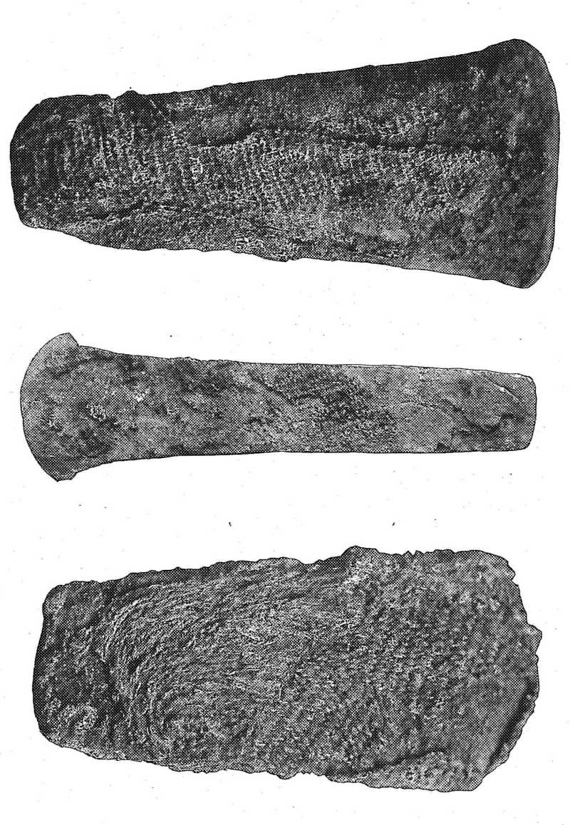COPPER CELTS WITH REMNANTS OF CLOTH.