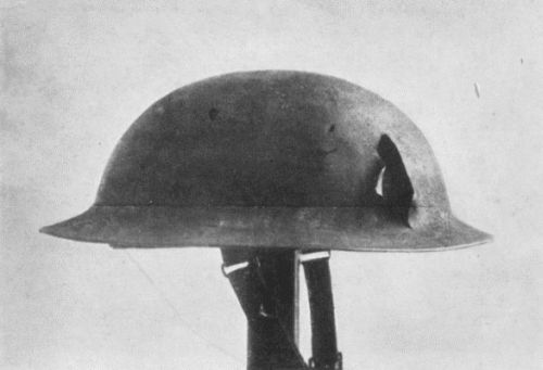 HELMET WORN BY FLOYD GIBBONS WHEN WOUNDED, SHOWING DAMAGE CAUSED BY SHRAPNEL