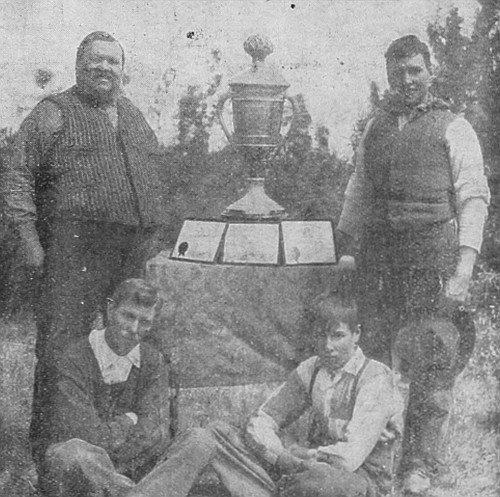Mr. J. C. Hill & Sons, of Lloydminster, Saskatchewan, who recently became winners for the third time of the Colorado Silver Trophy, valued at $1500 for best peck of oats in the world. They now own the trophy.