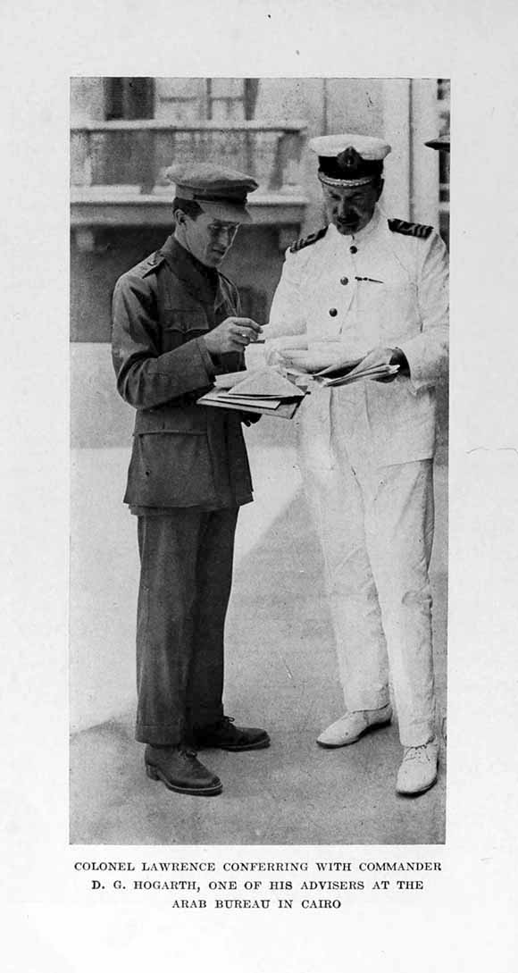 Photograph: COLONEL LAWRENCE CONFERRING WITH COMMANDER D. G. HOGARTH, ONE OF HIS ADVISERS AT THE ARAB BUREAU IN CAIRO