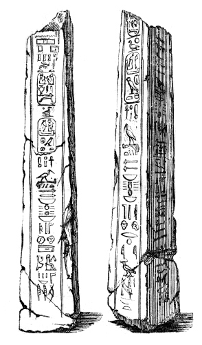 Two broken obelisks, covered in hieroglyphics.