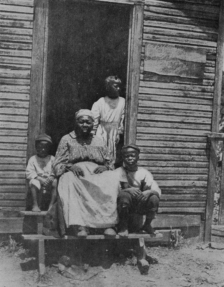 Picture of Zooma sitting on steps with three kids