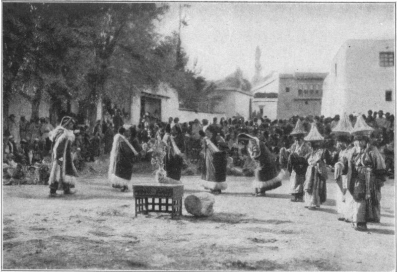 A group of people dancing, surrounded by onlookers