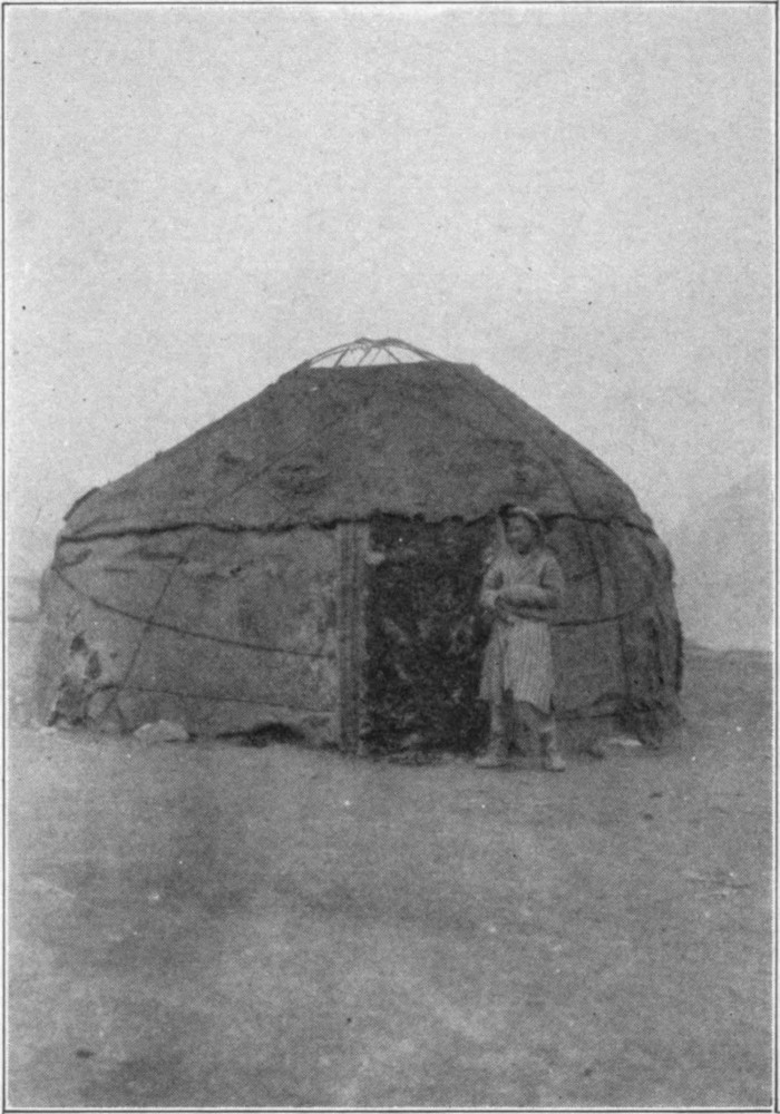 A yurt with a men stood at the entrance.