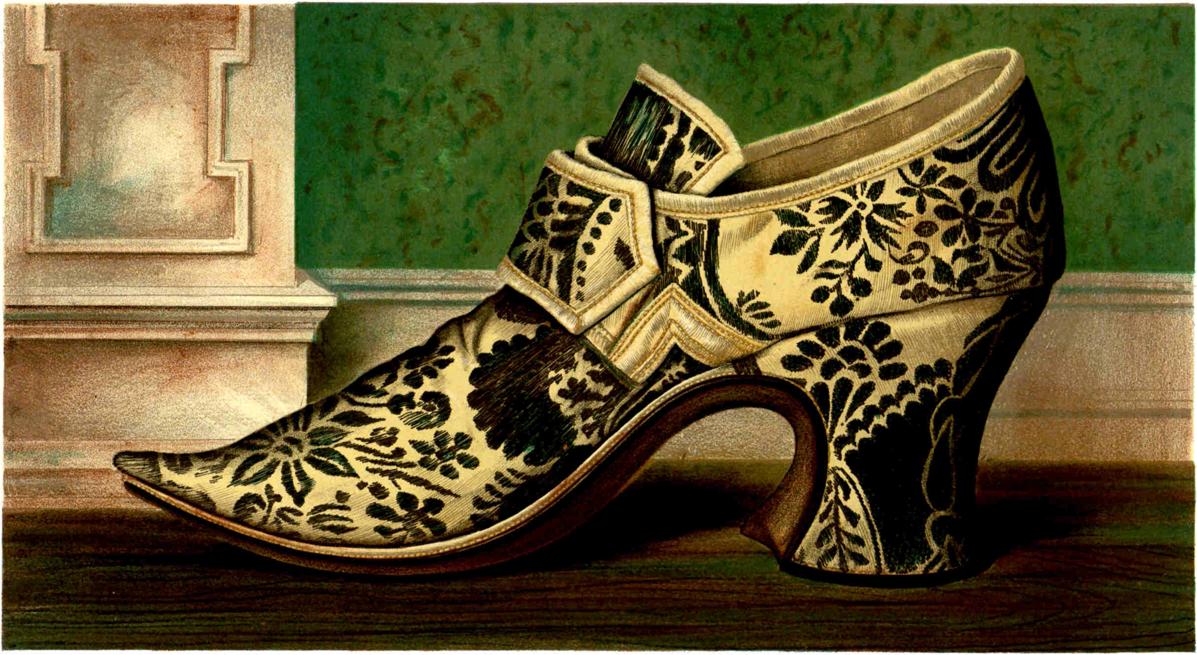 A cream-colored high-heeled shoe with a pointed toe, covered in a dark floral pattern and featuring a large folded strap across the front.