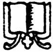 Decorative emblem of an open book with ornate scrollwork beneath