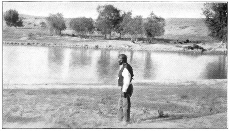 A man standing by a river
