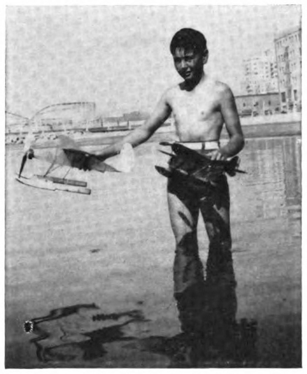 Picture of a boy with model seaplanes