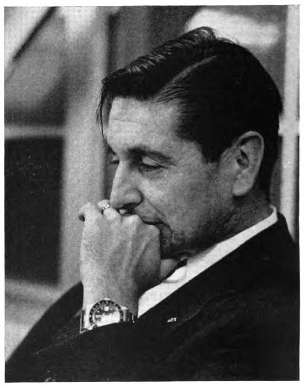 Picture of a man from the side with his hand upon his chin