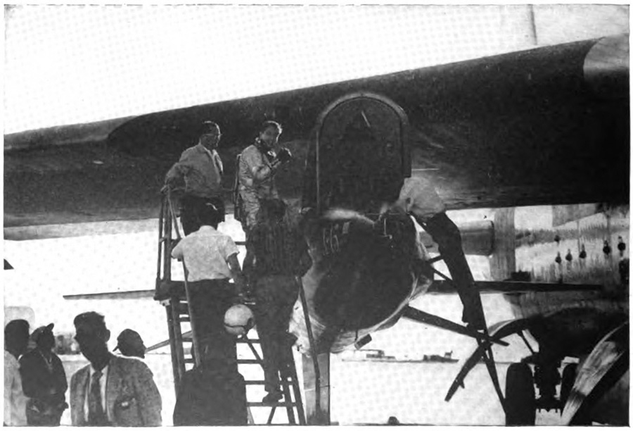 Men gathered around an airplane, some on a ladder