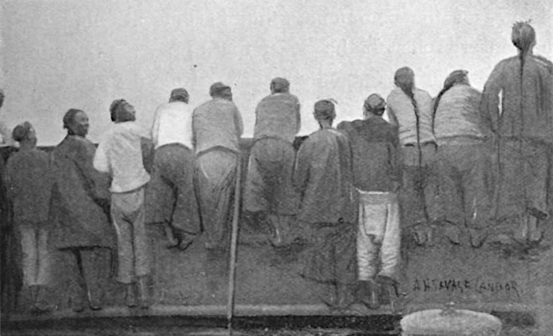 Photo of Chinese men facing away, along a wall