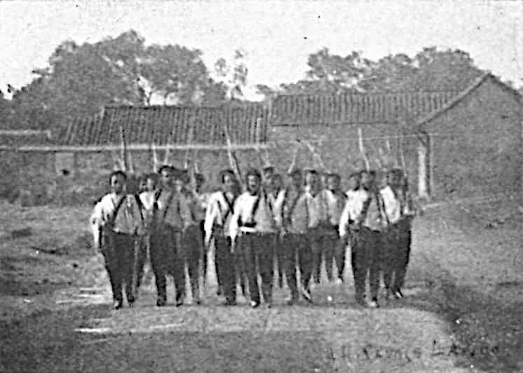 Group of men in uniform in front of building