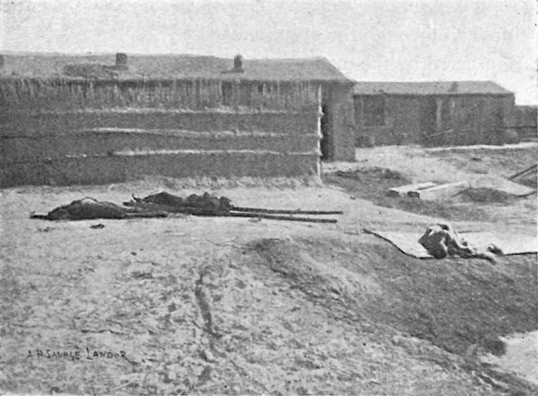 2 dead bodies in front of buildings