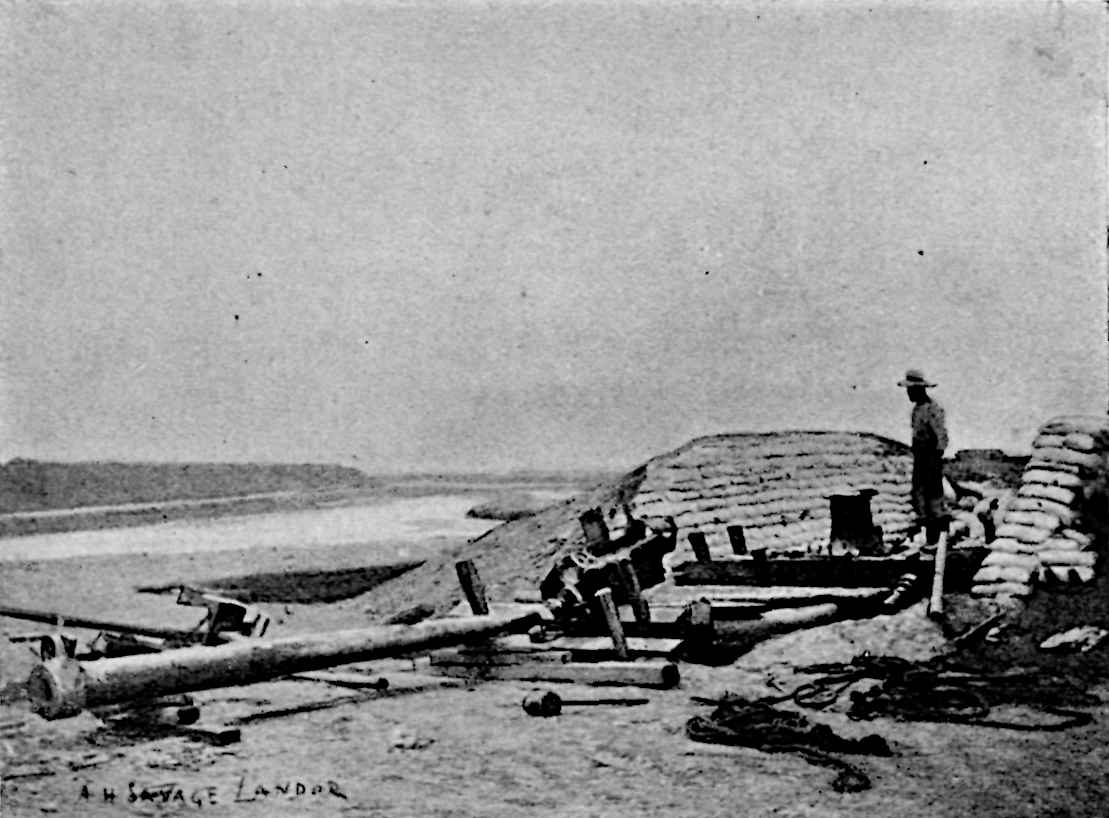 A large artillery-gun between fortifications of sandbags