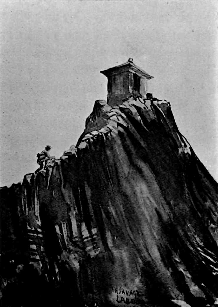 Man climbing a narrow ridge to the summit, where there is a building