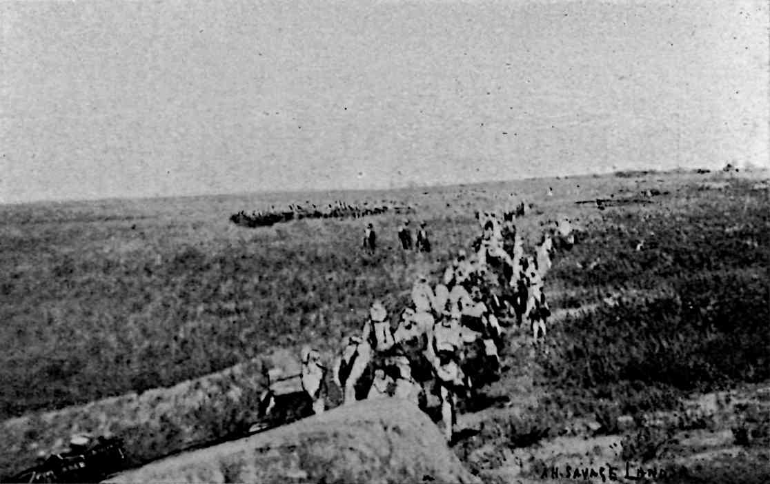 People walking across field, with several different lines of people