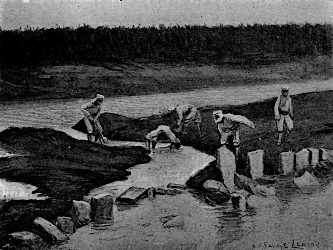 People using shovels to block a small cut near a river that causes water to flow into the foreground
